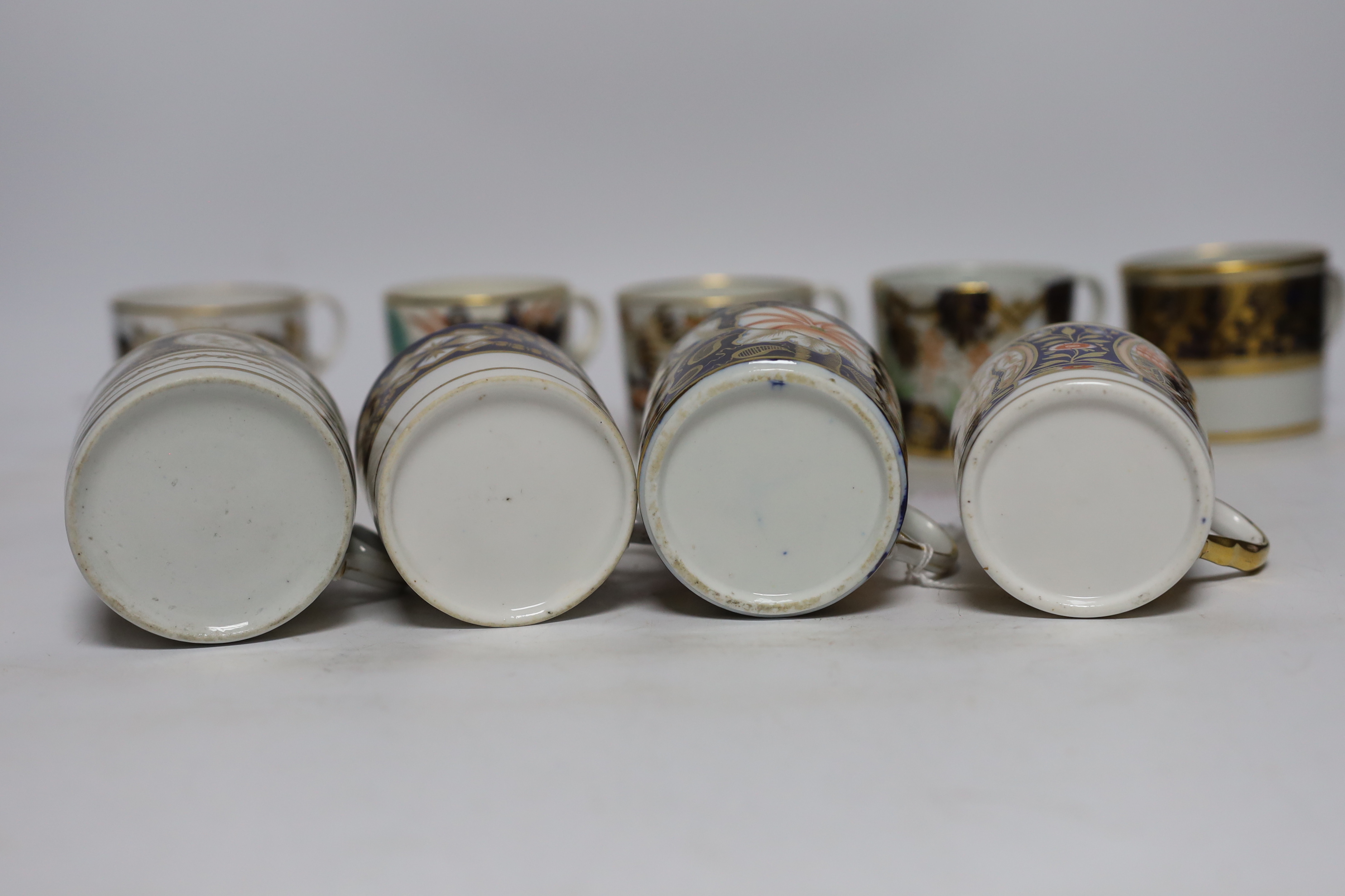 Twelve 1800-1820 English porcelain coffee cans, including Imari pattern examples